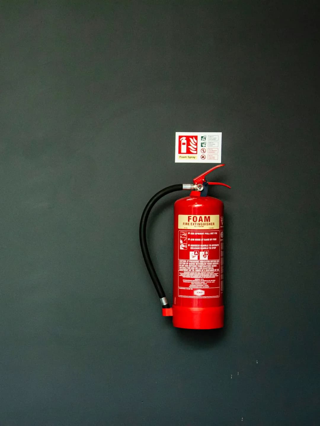 An engineer testing a fire extinguisher in a commercial kitchen