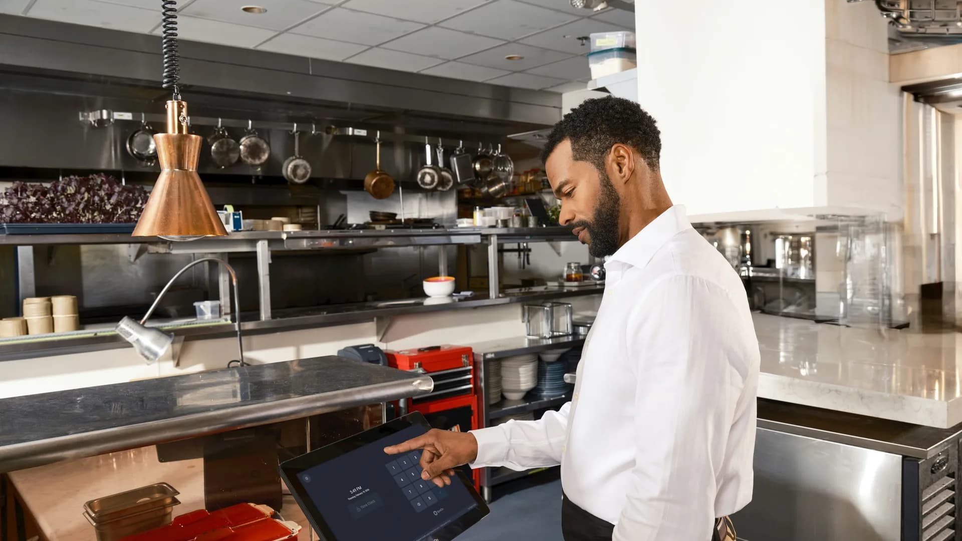 A technician working on a commercial cooking line during a scheduled visit